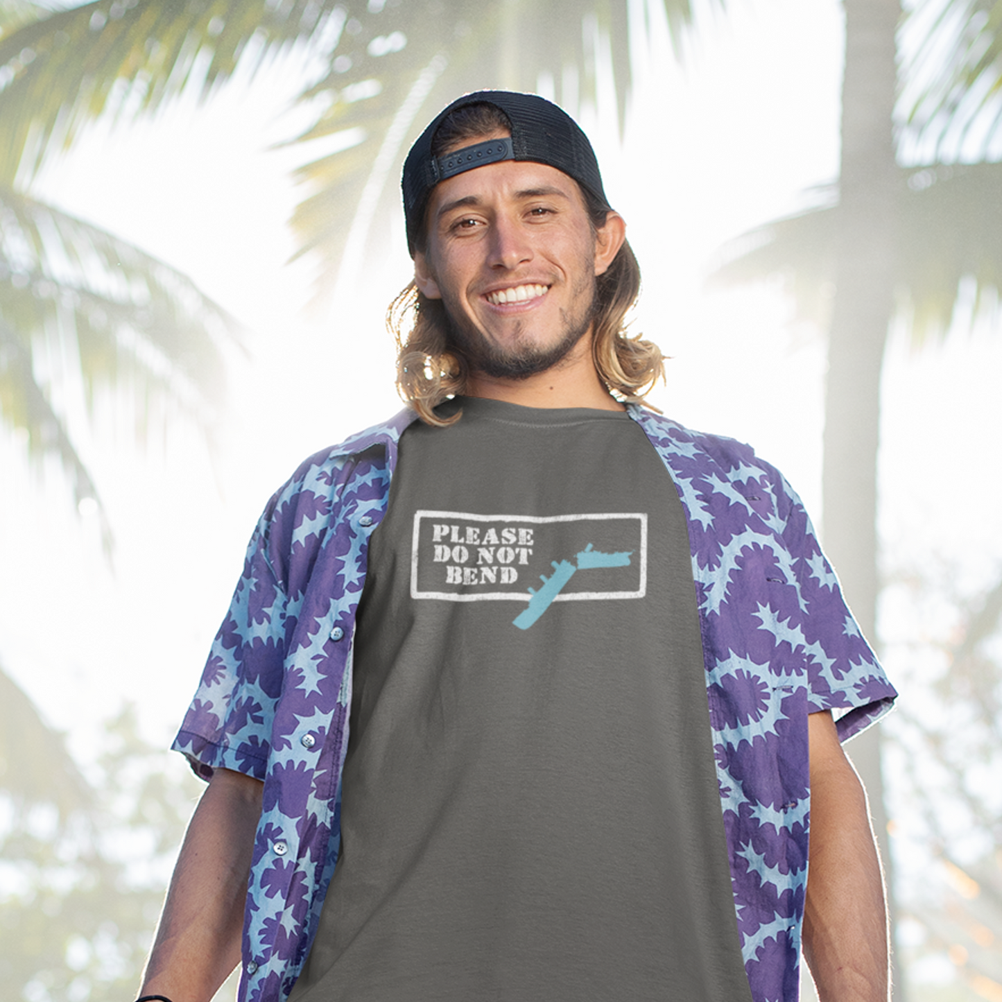smiling man wearing cruise shirt and backwards baseball cap